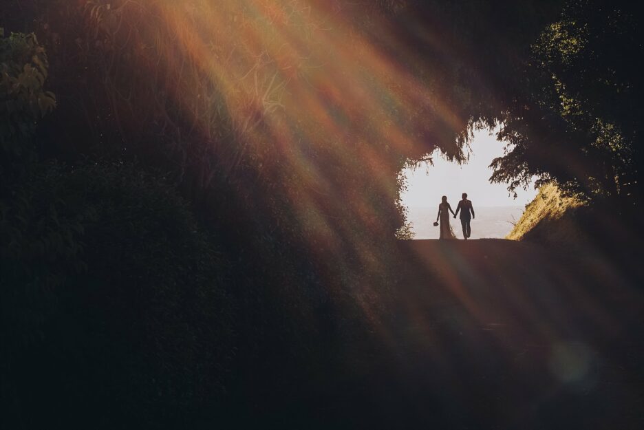 Bridal couple walking with sunset in hills