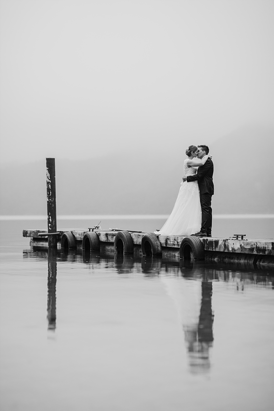 Kissing photo at Lake Okataina Bride and Groom