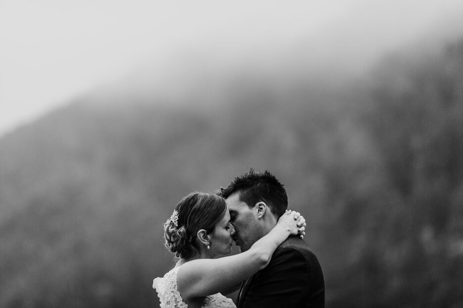 Kissing in the rain on wedding day