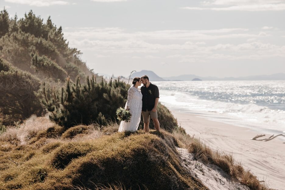 Wedding couple by the forest with Mauao by the beach