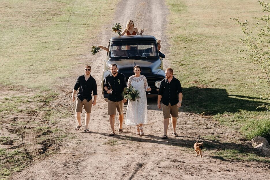 Vintage truck with bridal party and puppy
