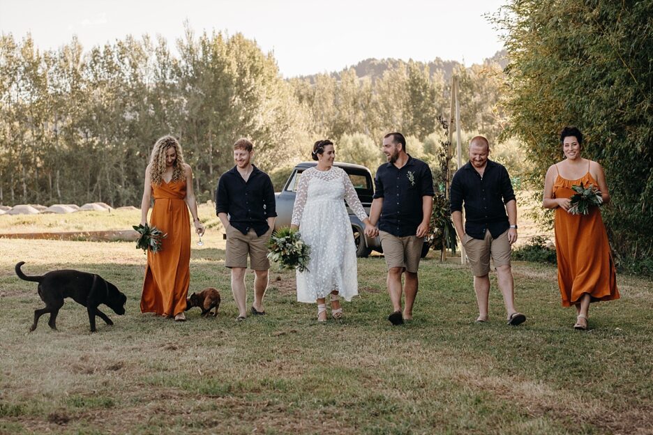 Country rustic wedding party walking with pets