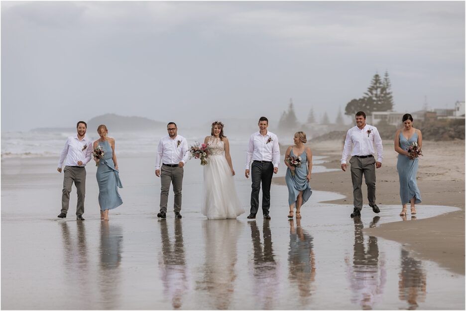 Wedding party walking Waihi Beach