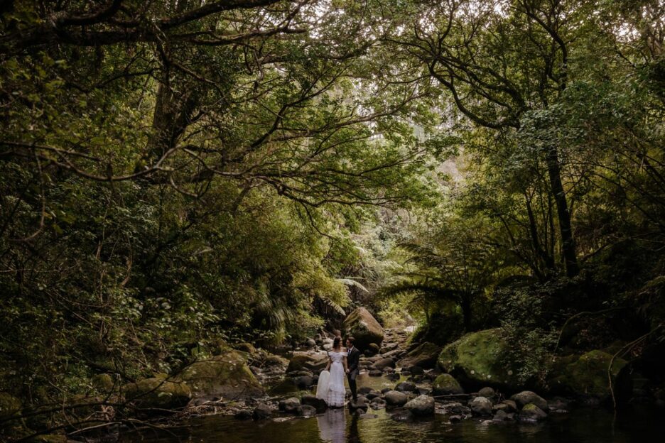 Elopement couple by stream in New Zealand