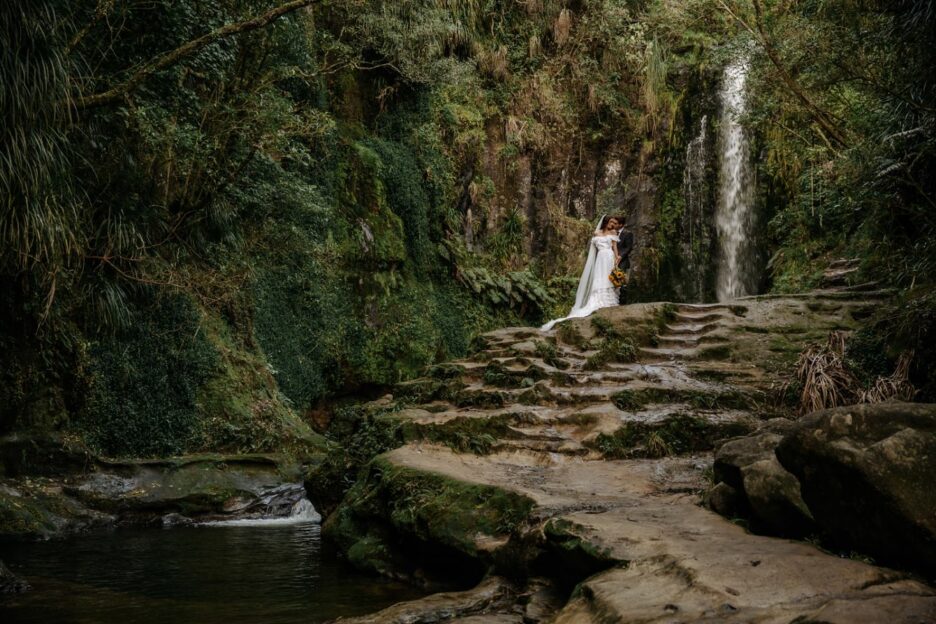 Waterfall wedding picture surrounded by natural NZ bush