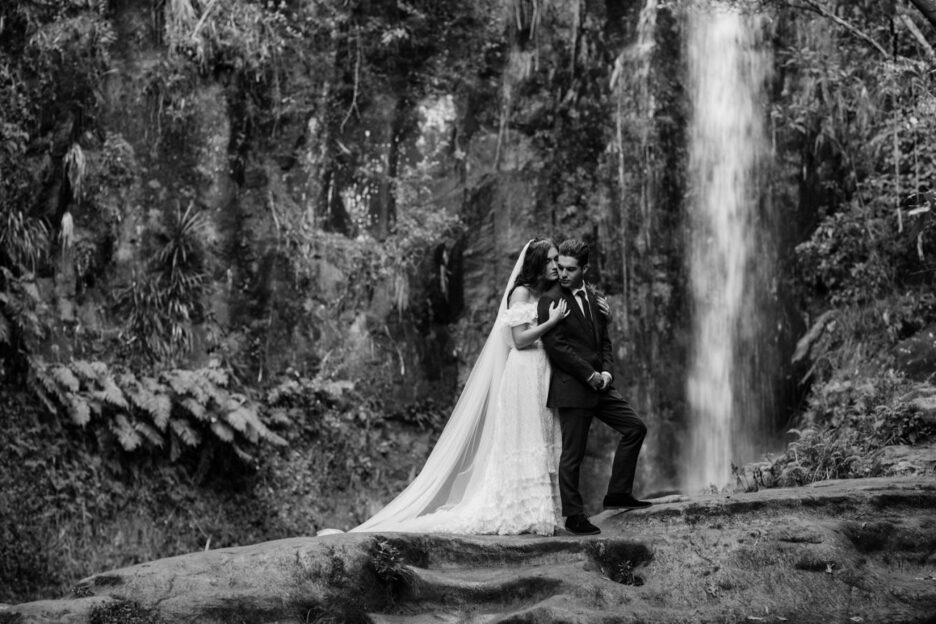 Lovely black and white photos moment elopement couple in front of waterfall