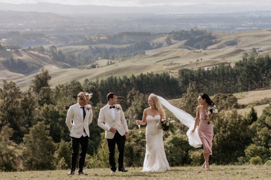 Wedding party laughing in the hills