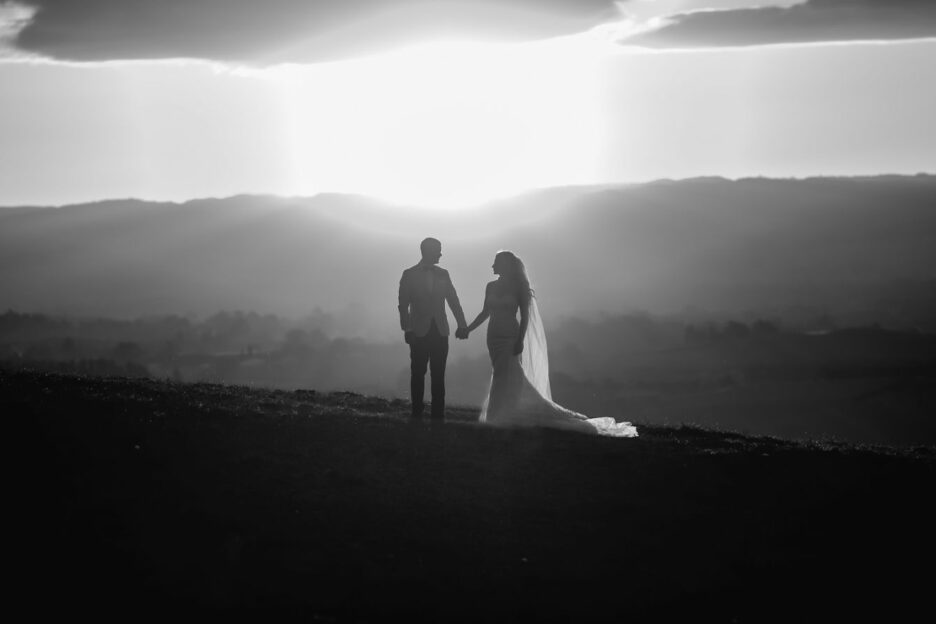 Wedding photos on top of hill with sun setting
