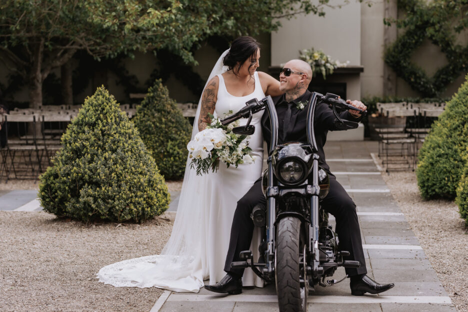 Bride and groom on Harley Davidson motor bike at Ataahua garden ceremony area