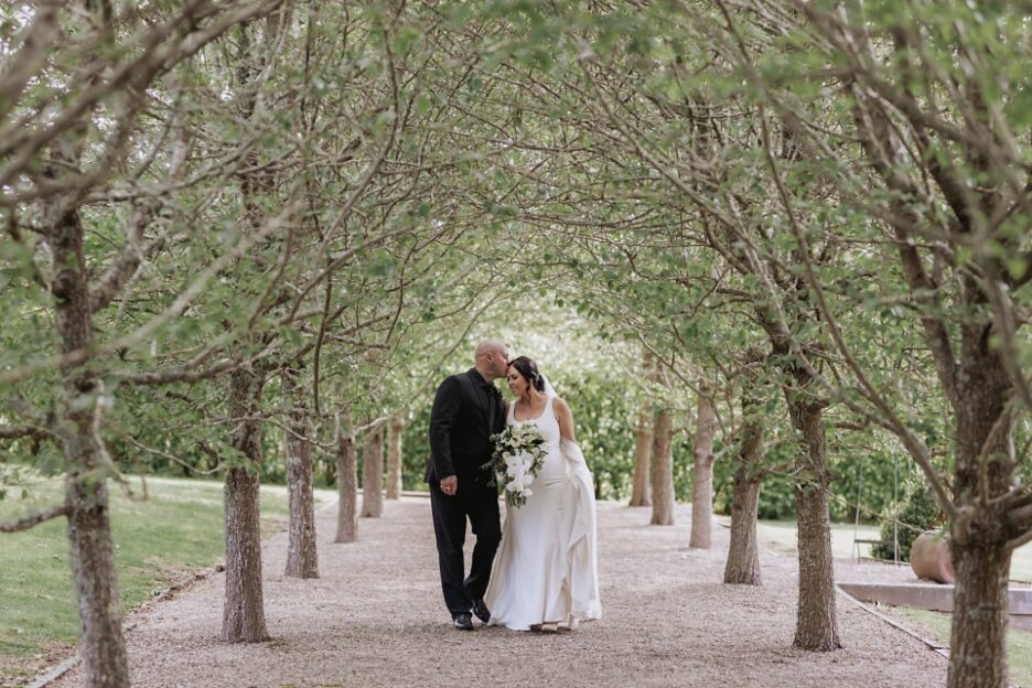 Beautiful moment between bride and groom Ataahua pear Trees