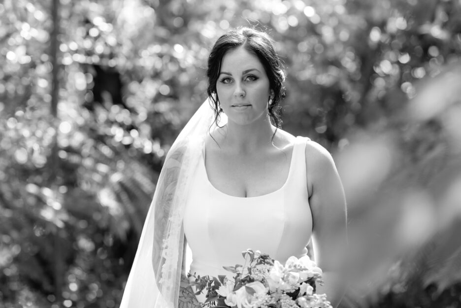 Black and white wedding image of bride in farm track
