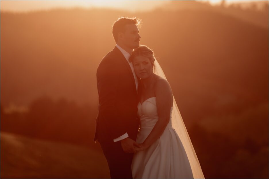 Beautiful intimate moment captured of bride and groom at sunset