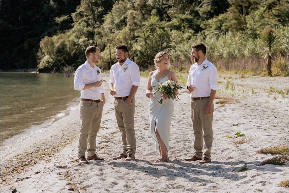 Groom with his grooms men and woman on the lake front