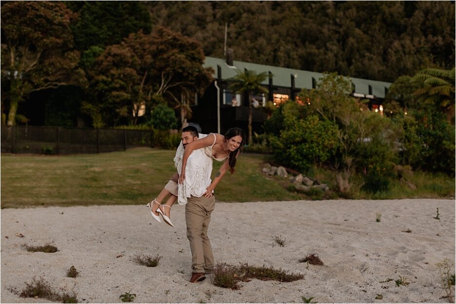 Groom carrying bride back to lodge