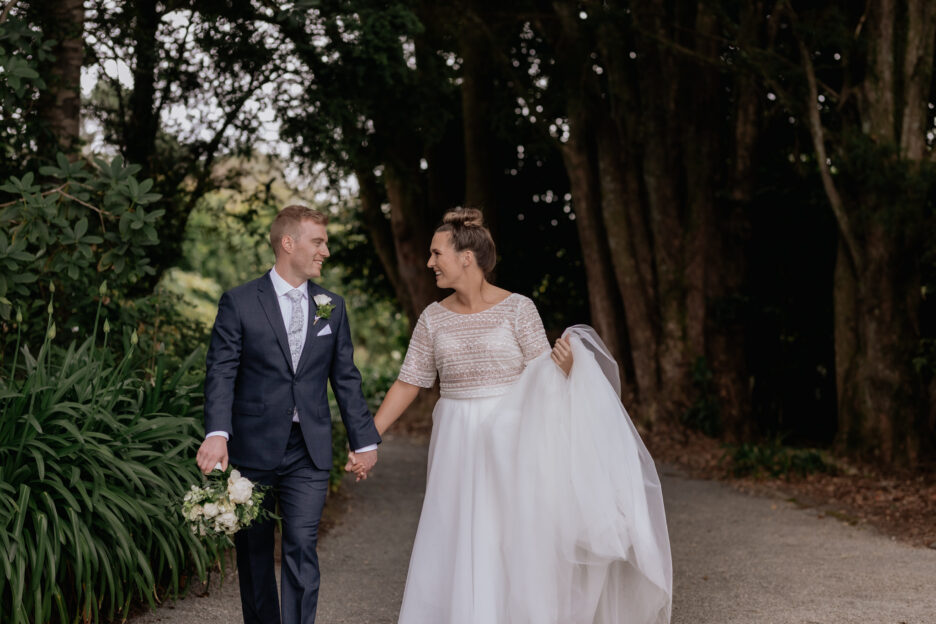 Bride and groom walking on a country lane