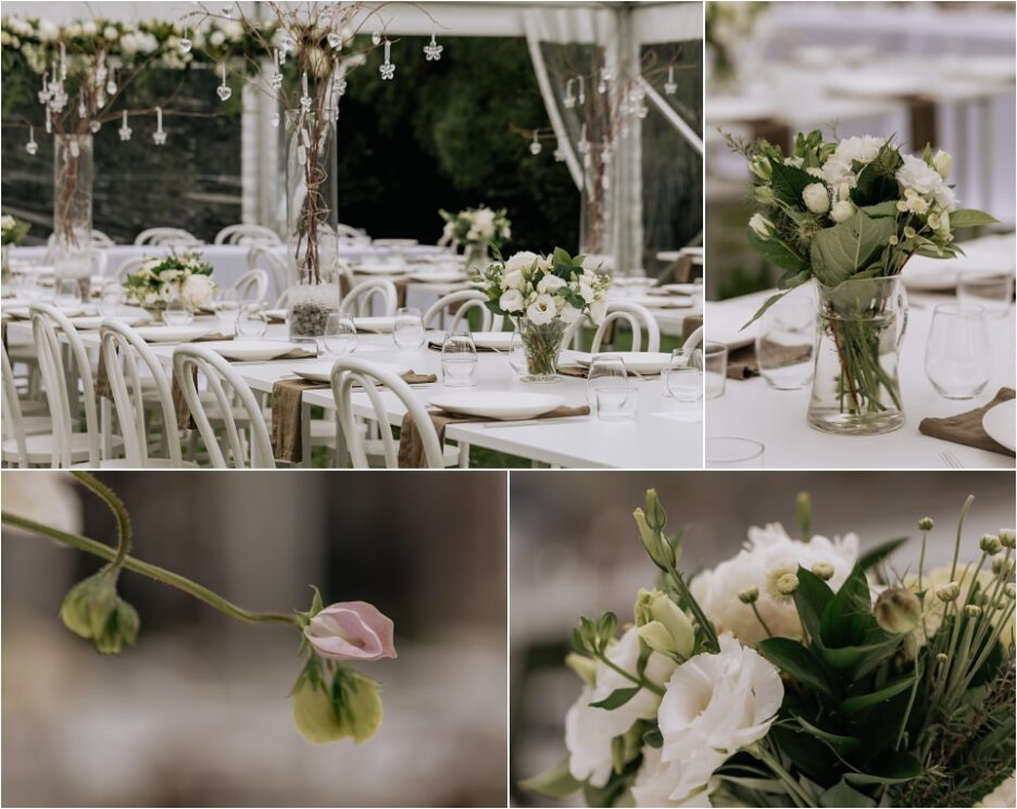 Flower arrangements and table settings for wedding reception inside marquee