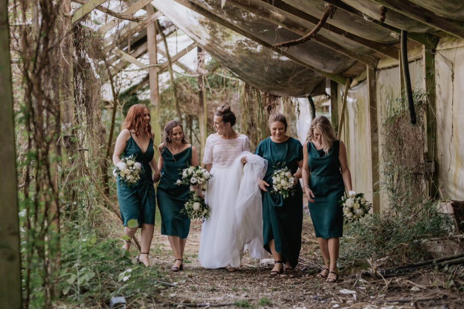 Bride with bridesmaids in abandoned glass house