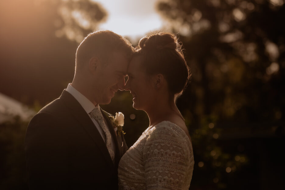 Low golden moody light with bride and groom