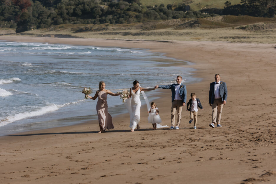 Bridal party walking on hot water beach