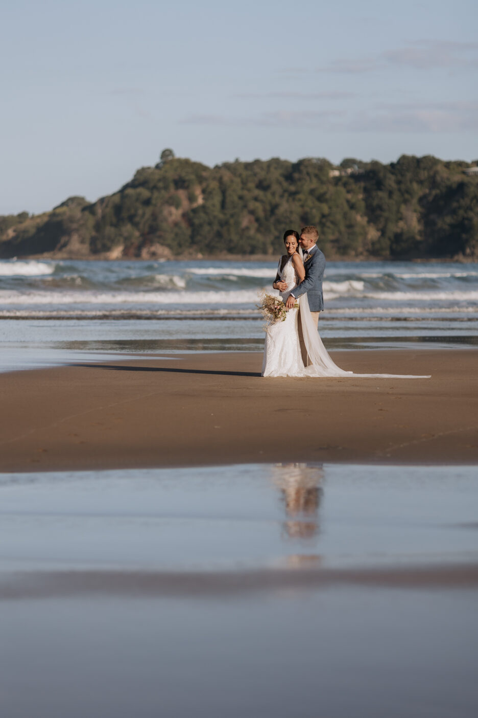 Bride and groom on beach at Hot water beach Coromandel