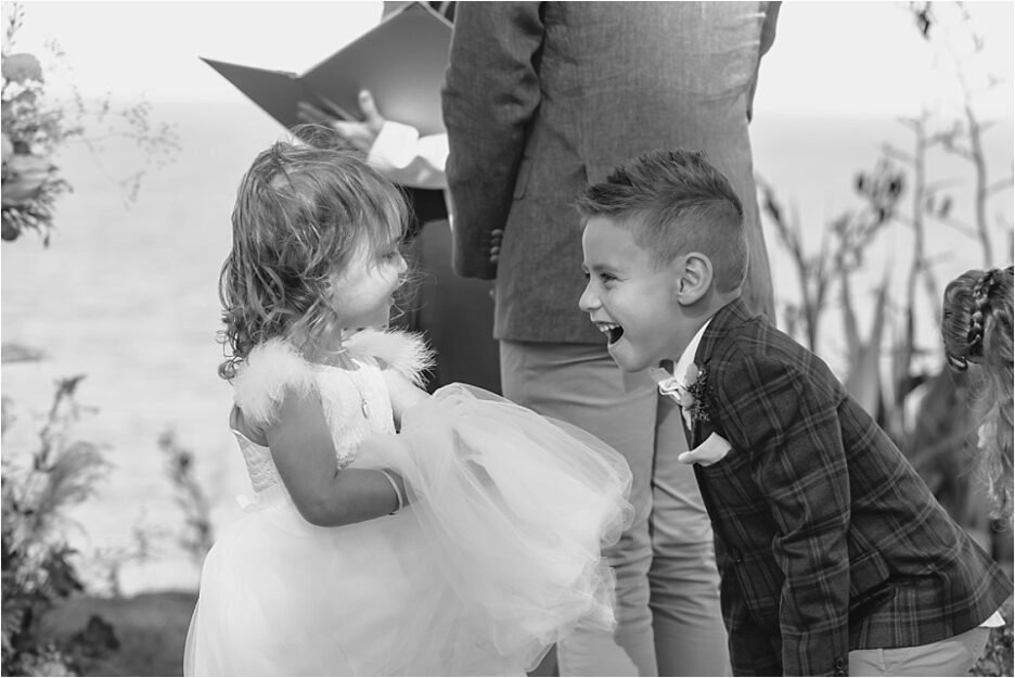 Page boy laughing with flower girl