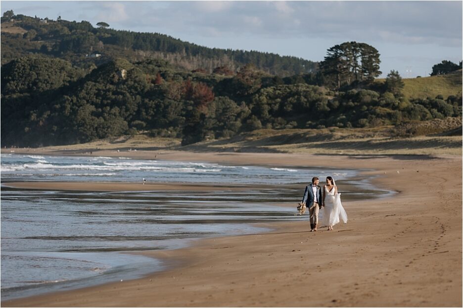 Orua Beach house Bride and Groom walking