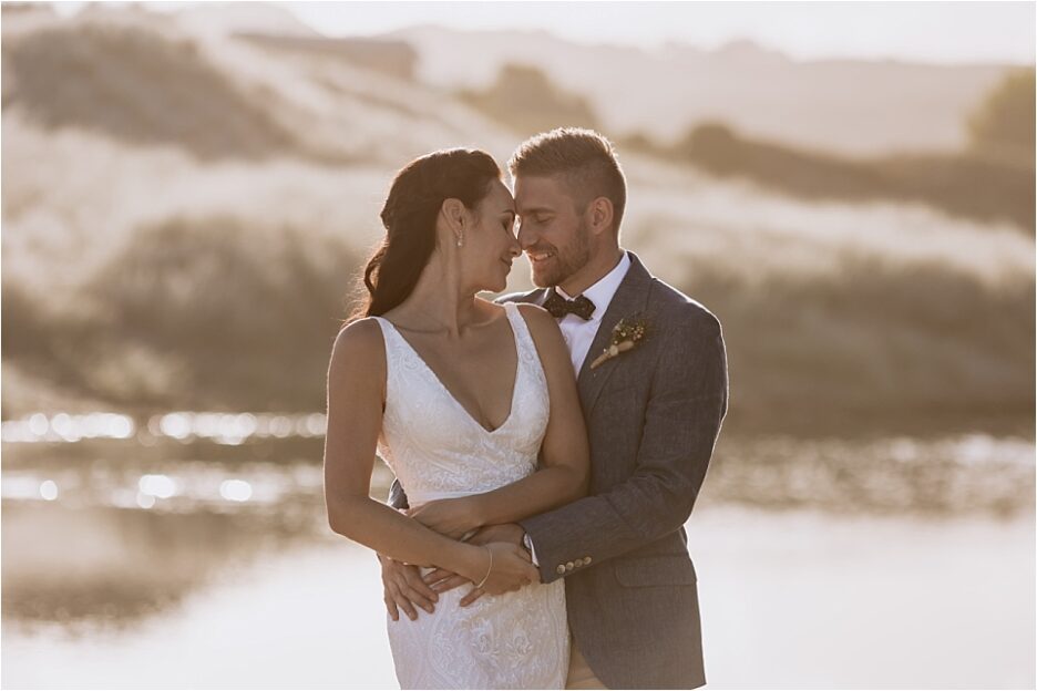 Initmate moment in golden light during wedding photography on Hot Water Beach New Zealand