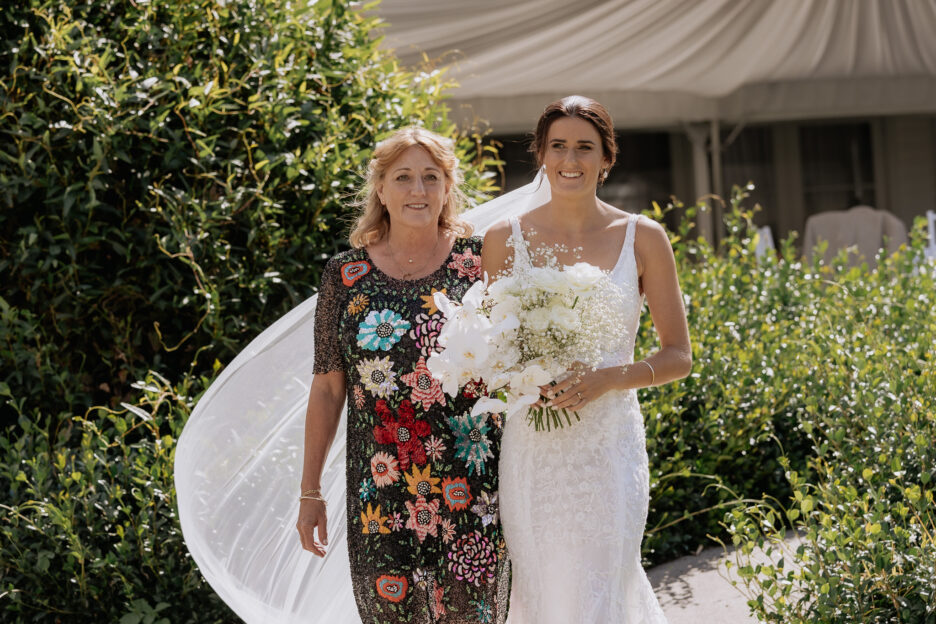 Mother walking daughter down aisle