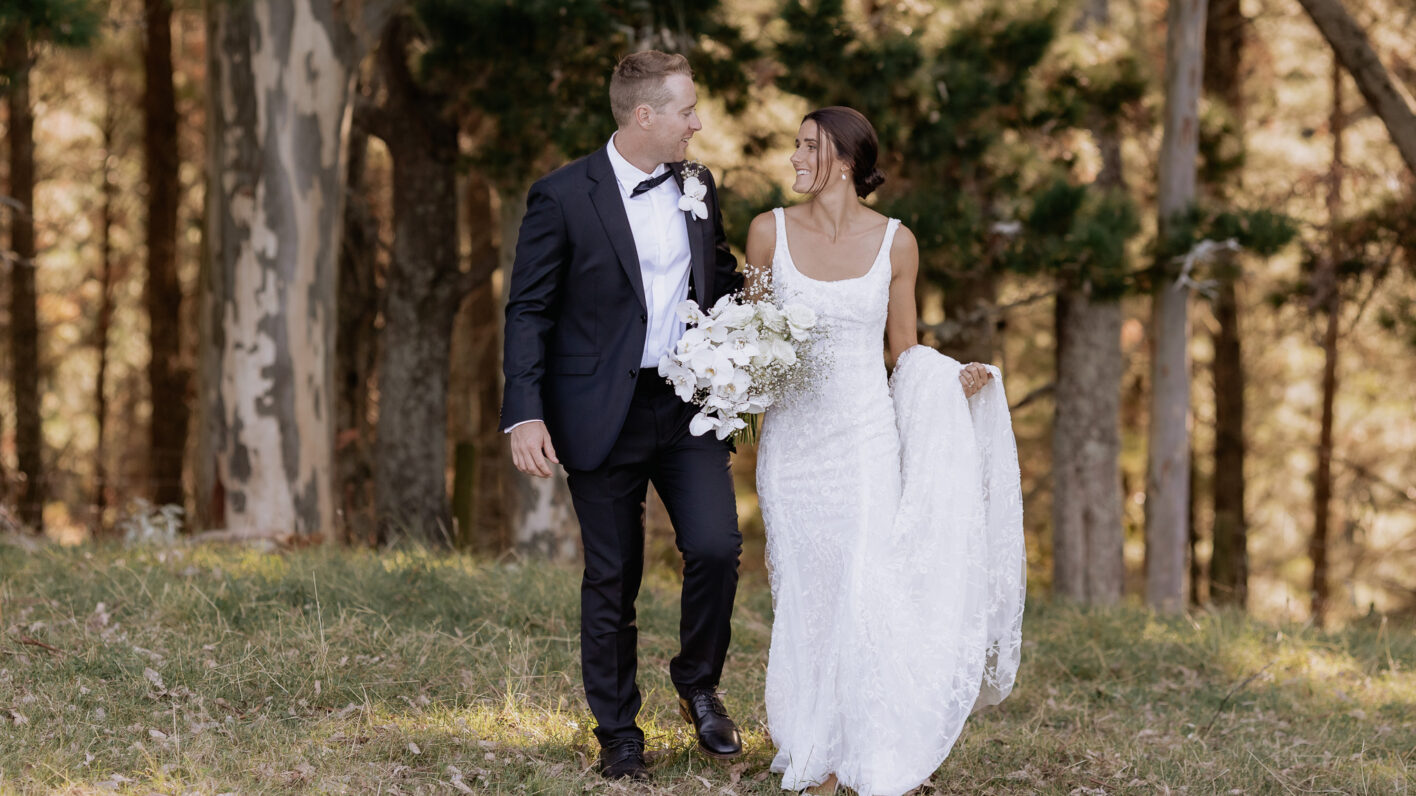 Wedding couple walking in country field