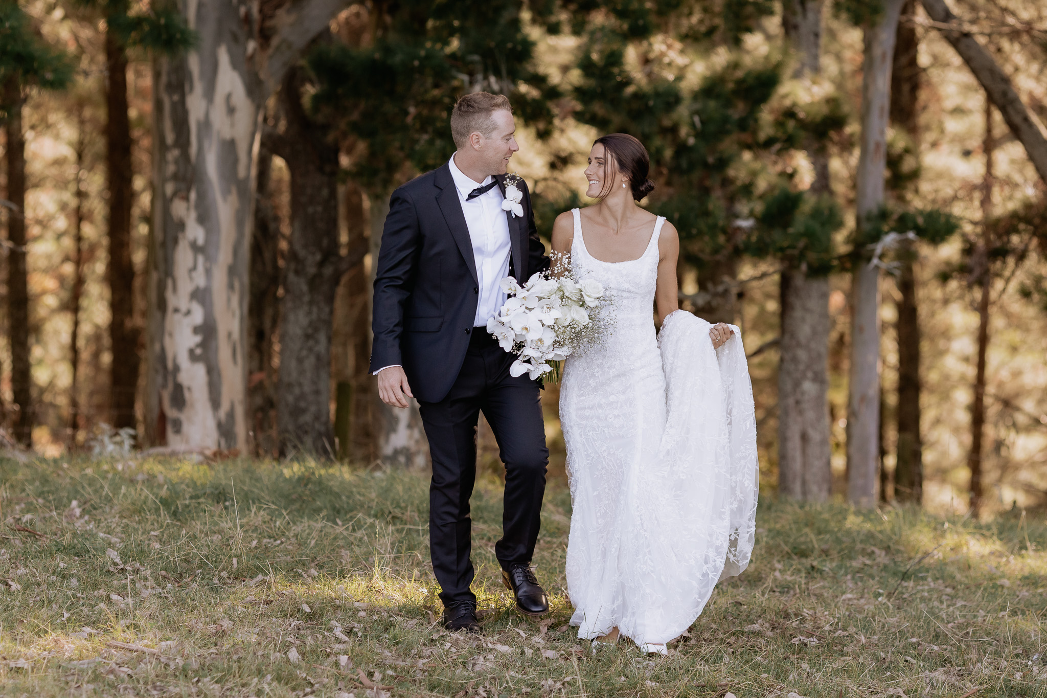 Wedding couple walking in country field