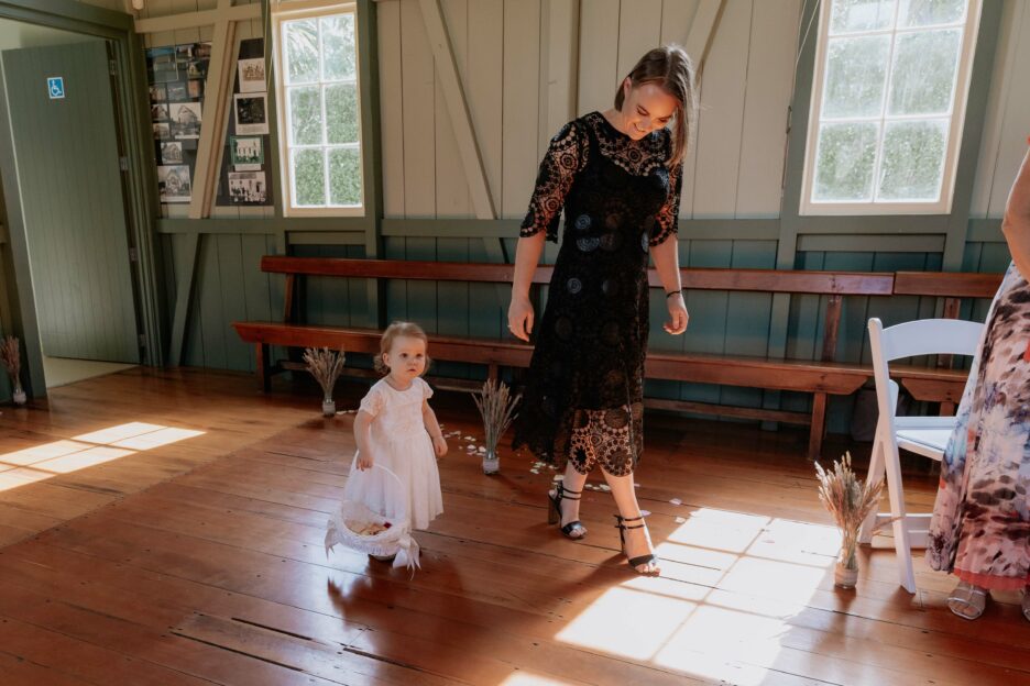 Flower girl with bridesmaid in black dress