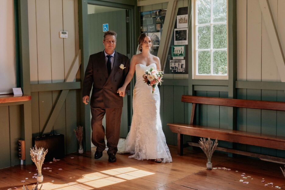 Father of the bride and daughter walking down the aisle at number 2 road country hall