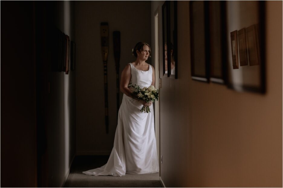 Bride in door way during portraits at Quail Lodge accommodation in Auckland