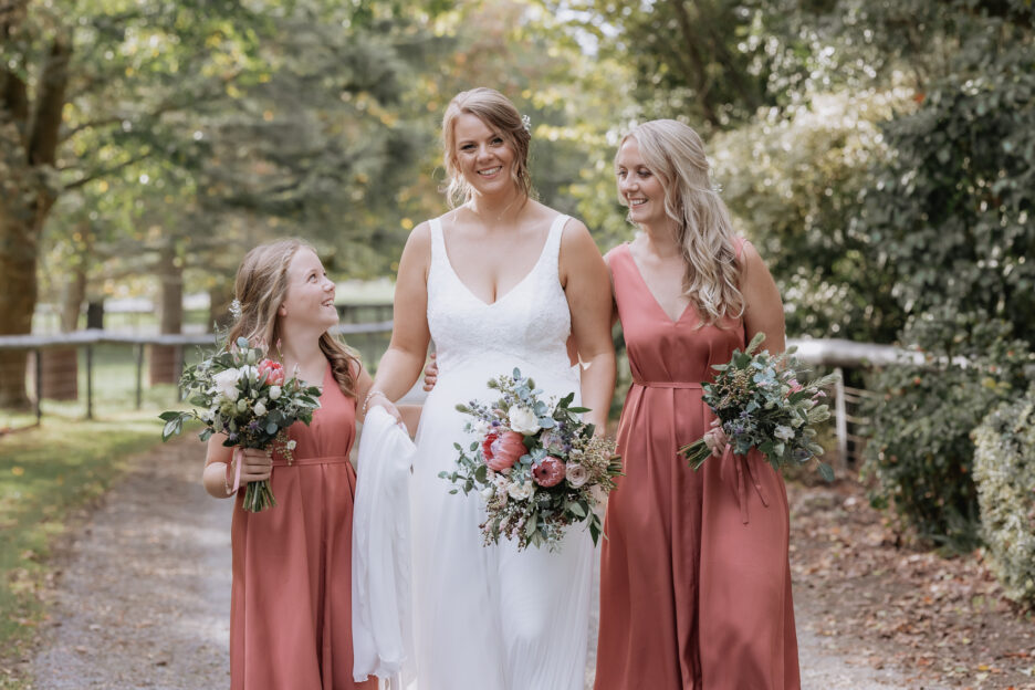 Happy country bride her girls in blush pink dresses