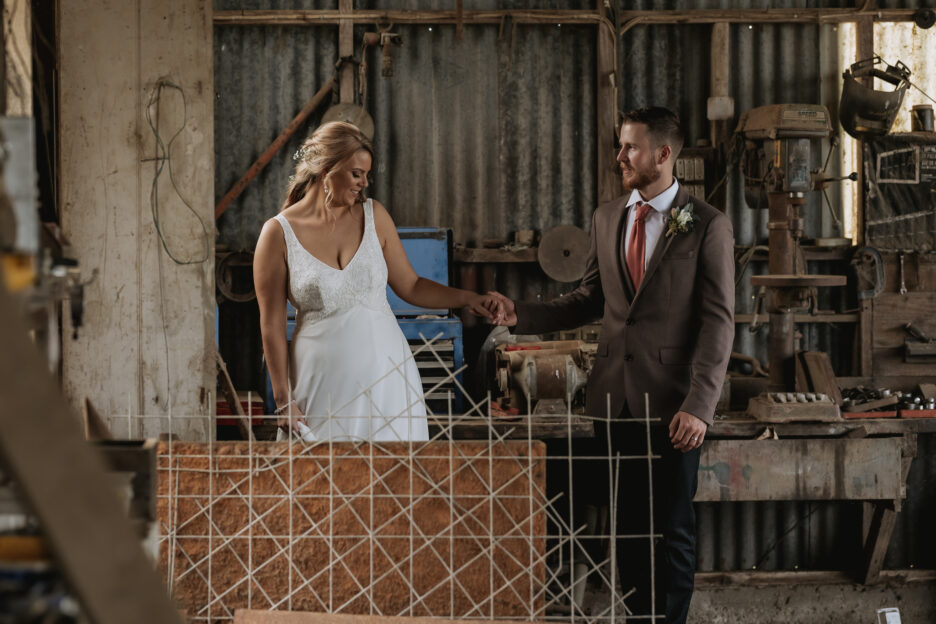 canidid moments with bride and groom in country shed