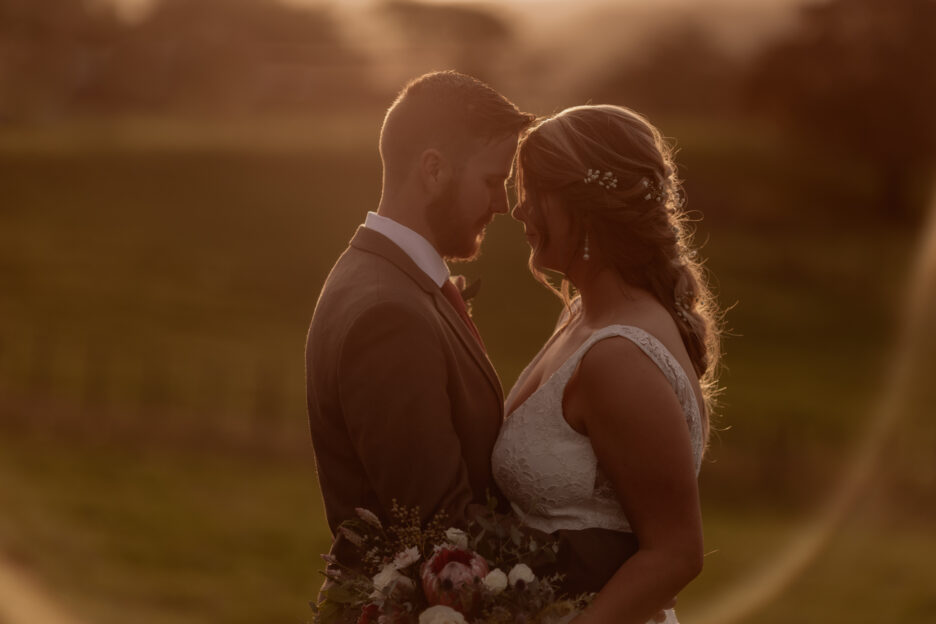 golden hour photos of farm wedding bridal couple