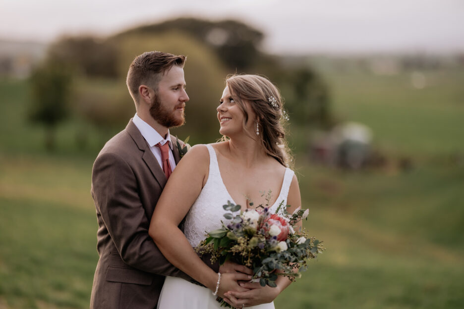 bride turning to look at groom countryside rustic wedding
