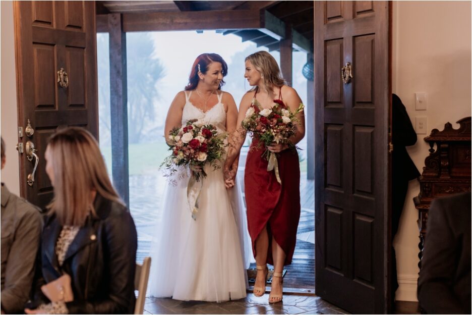 Bride arrives to aisle with bridesmaid