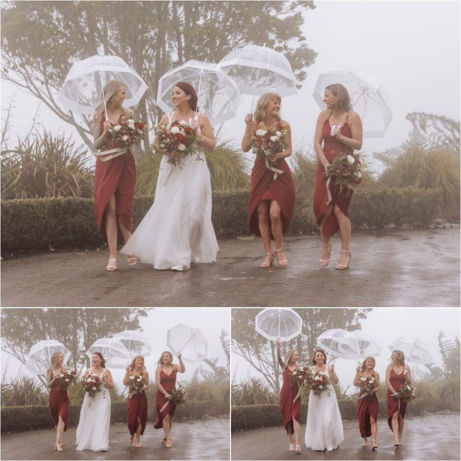 Laughing bridesmaids with bride with umbrellas laughing in the rain