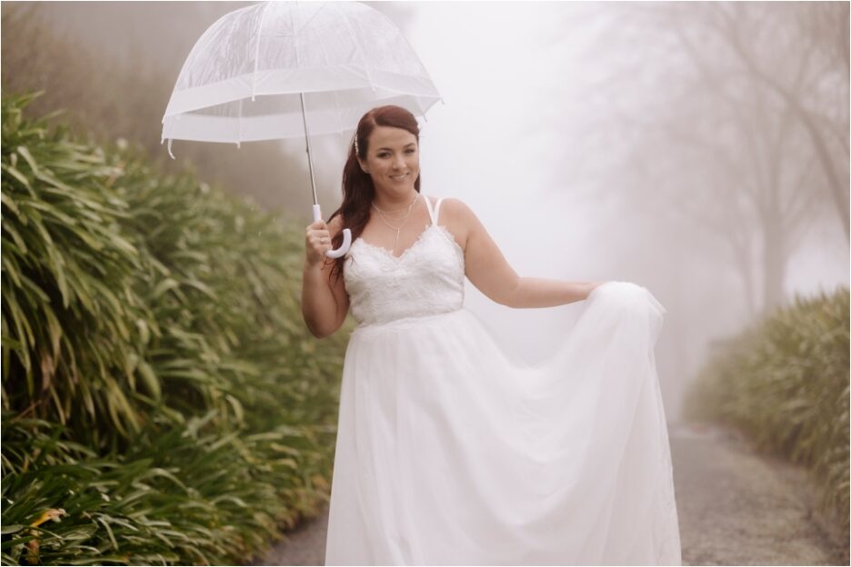 Happy bride walking in the rain