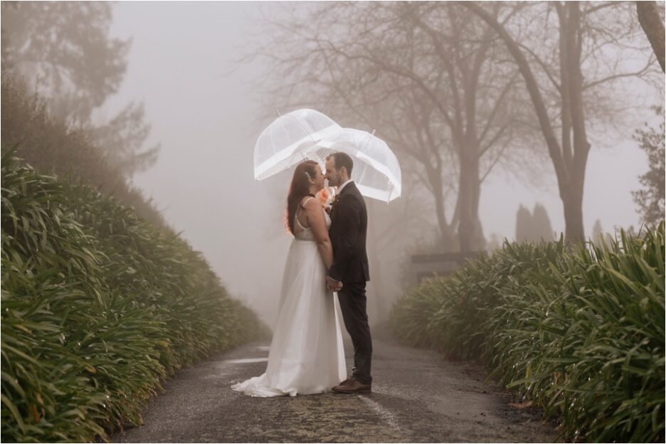 Wedding photos with lit umbrellas on wet rainy day