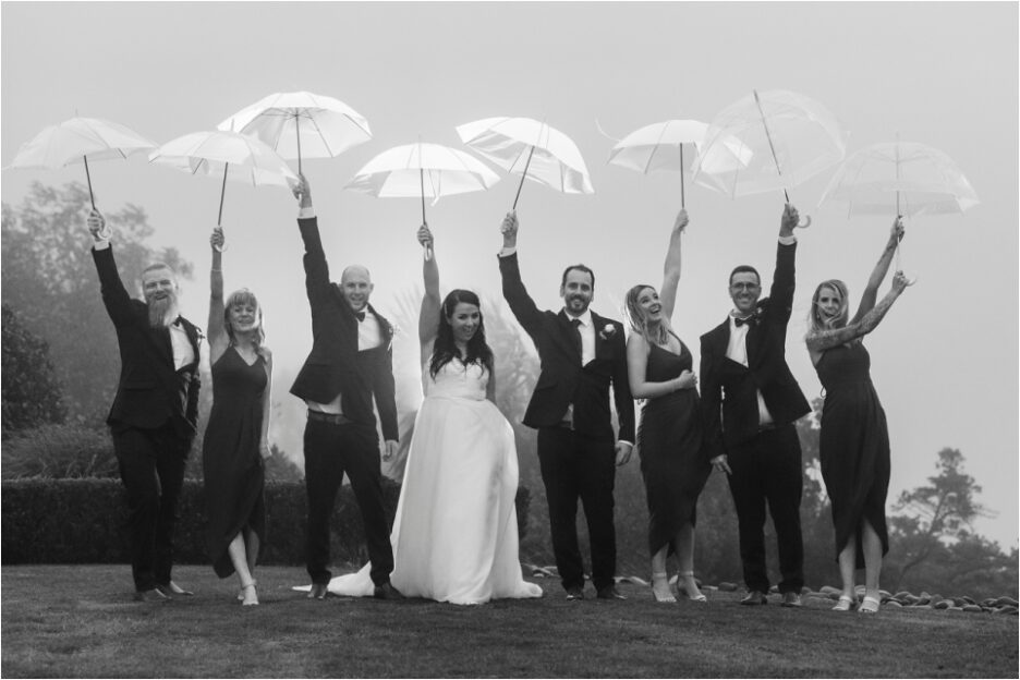 Fun happy photos wedding party holding up umbrellas