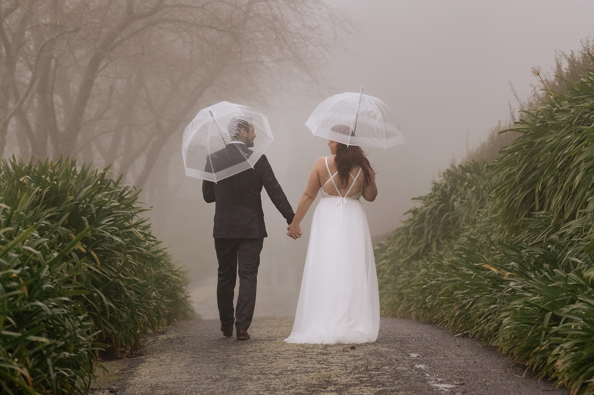 walking in the rain wedding couple