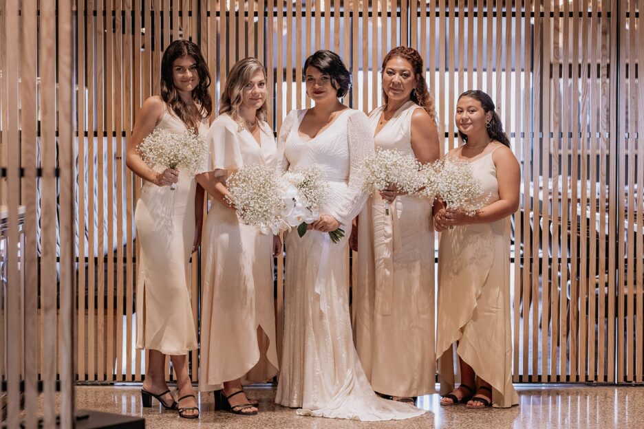 Bride with bridesmaids in their blush pink blak dresses