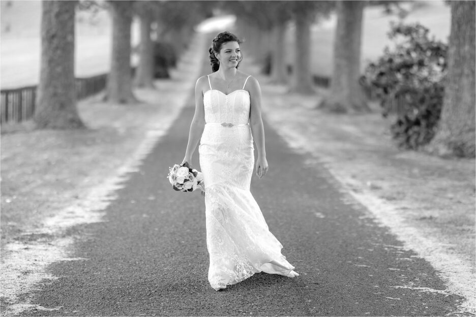 Happy bride walking on country driveway
