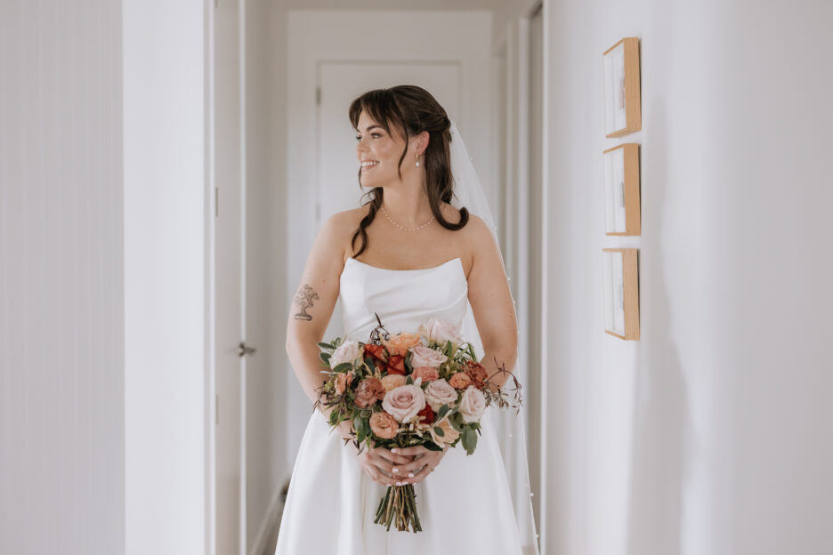 bride in astra bridal dress with wild bella bouquet