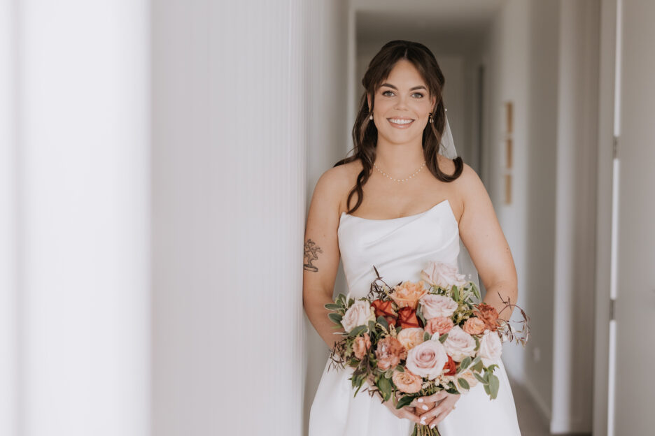 bride in white astra bridal hamilton dress with country floral bouquet