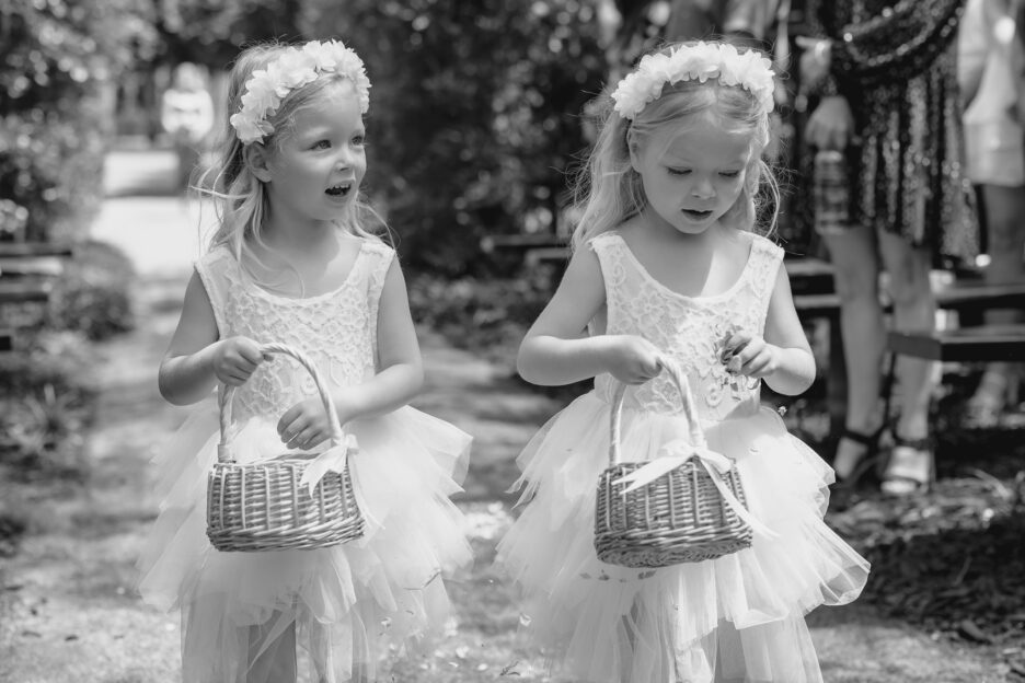 flower girls walking down tree church aisle