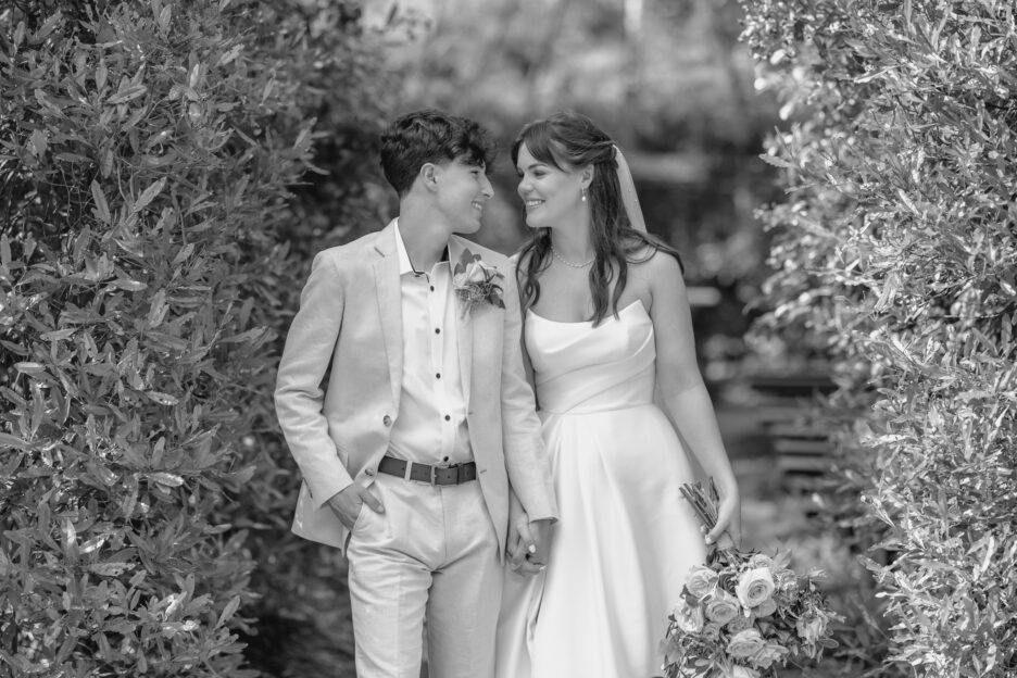 bride and couple looking at each other walking out of tree church