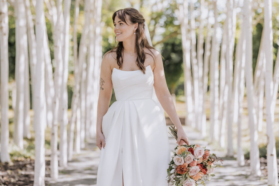 bride walks in trees at tree church wedding by Pure Images photography